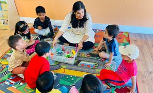 Children engaged in hands-on activity at Level Up Montessori preschool program.