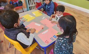 Children engaged in a learning activity at Level Up Montessori classroom.