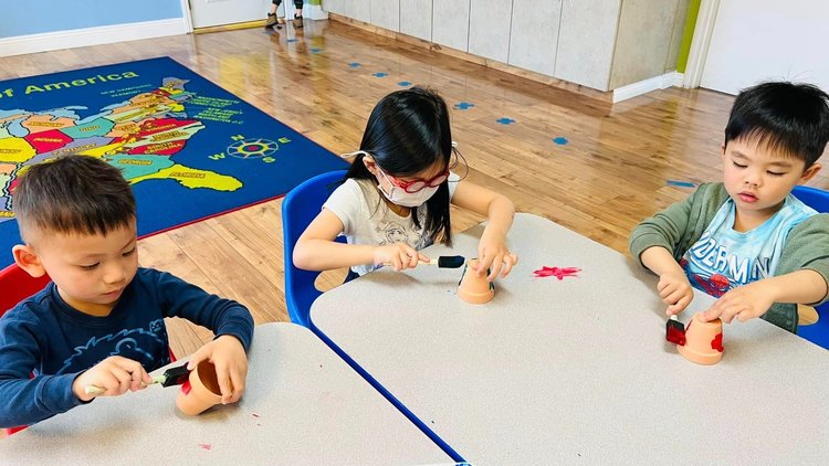 Children engaged in learning activity at Level Up Montessori classroom.