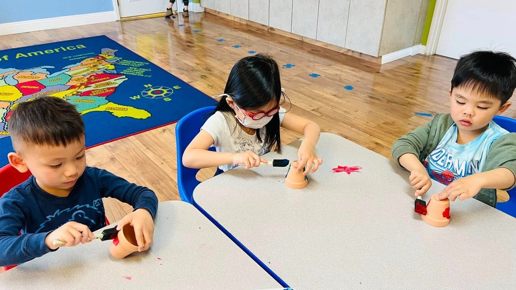 Children engaged in learning activity at Level Up Montessori classroom.