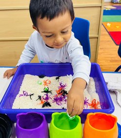 Child engaging in Montessori activity to build confidence and early academic skills for kindergarten readiness.