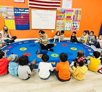 Montessori students in a circle during a classroom activity focused on learning at Level Up Montessori.