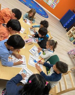 Children engaged in a coloring activity at Level Up Montessori classroom.