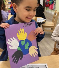 Child in Level Up Montessori preschool showcasing a colorful hands-on art project.