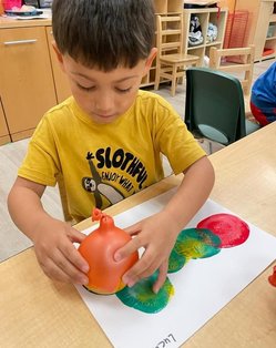 Child engaged in hands-on art activity at Level Up Montessori preschool.