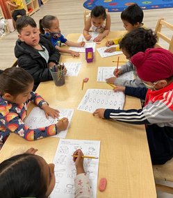 Children engaged in learning activities at Level Up Montessori classroom.