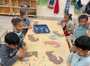 Children engaging in a colorful Montessori activity at a table, enhancing learning and creativity.