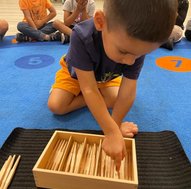 Child engaging in Montessori activity, building early skills and confidence for kindergarten readiness.