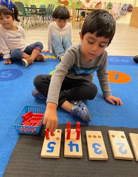 Children engaging in hands-on learning at Level Up Montessori preschool, exploring early academics and daily routines.