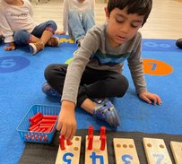 Children engaging in hands-on learning at Level Up Montessori preschool, exploring early academics and daily routines.
