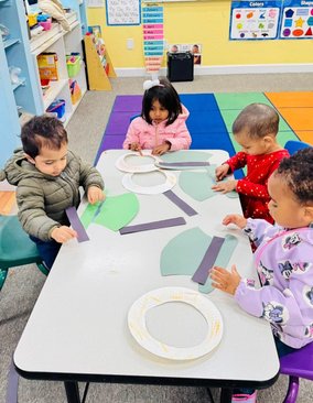 Toddlers engaging in hands-on creative activities at Level Up Montessori to build confidence and early skills.