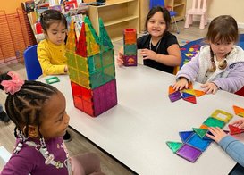 Children engage in hands-on learning and building activities at Level Up Montessori preschool classroom.