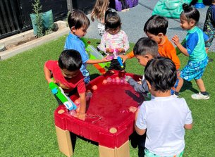 Children playing outside at Level Up Montessori after-school program for kindergartners with nearby school pick-up.