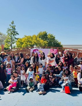 Group of people celebrating in a sunny outdoor setting.