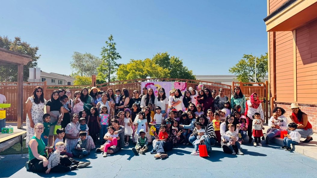 Group of people celebrating in a sunny outdoor setting.