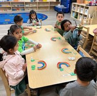 Toddlers engaging in a hands-on learning activity at Level Up Montessori, building confidence and early skills.
