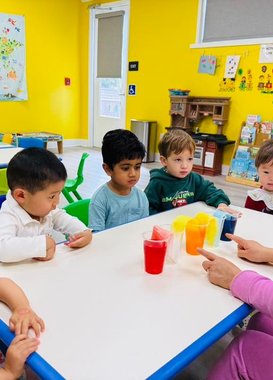 Toddlers at Level Up Montessori exploring hands-on activities and learning colors.