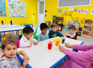 Toddlers at Level Up Montessori exploring hands-on activities and learning colors.