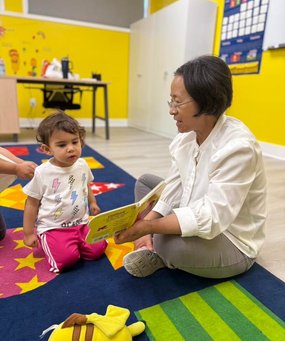 Teacher and toddler engaging in a hands-on learning activity at Level Up Montessori.