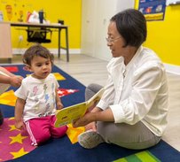 Teacher and toddler engaging in a hands-on learning activity at Level Up Montessori.