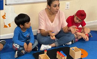 Teacher engaging with children in a Montessori setting, exploring career opportunities in the Bay Area.