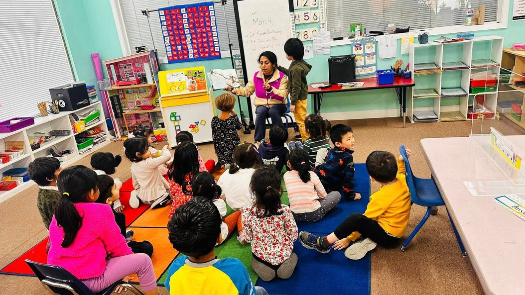 Montessori classroom with children engaged in a learning activity, fostering confidence and kindergarten readiness.