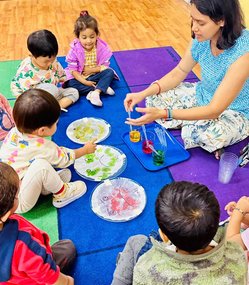 Children engaging in creative activities with a teacher at Level Up Montessori in the Bay Area.
