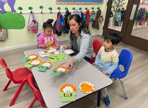Teacher and children doing crafts in a Bay Area Level Up Montessori classroom, highlighting supportive team culture.