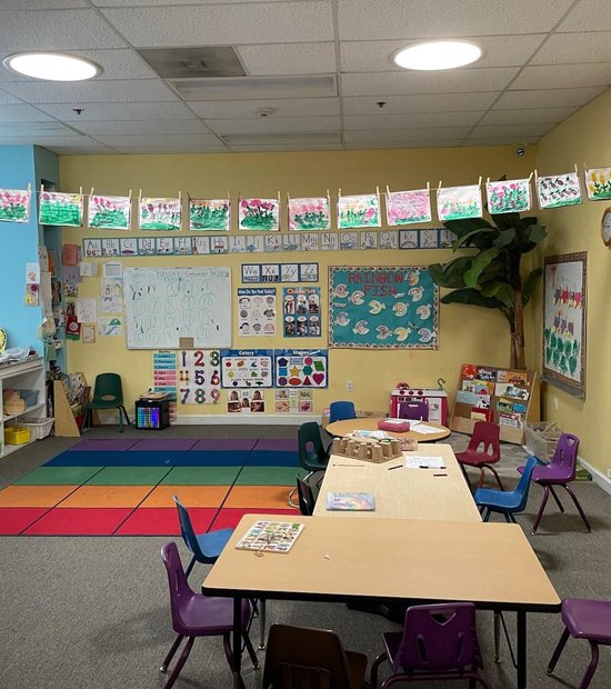 Colorful classroom with learning displays and child-sized tables at Level Up Montessori Milpitas.