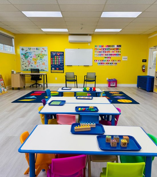 Bright Montessori classroom with activity trays on child-sized tables at Level Up Montessori Saratoga.