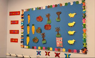 Montessori classroom display with colorful art pieces for children aged 12 months to 6 years.