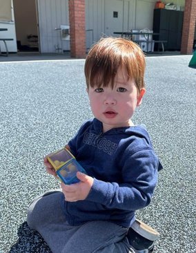 Infant engaged in play at Level Up Montessori, supporting early growth and discovery.
