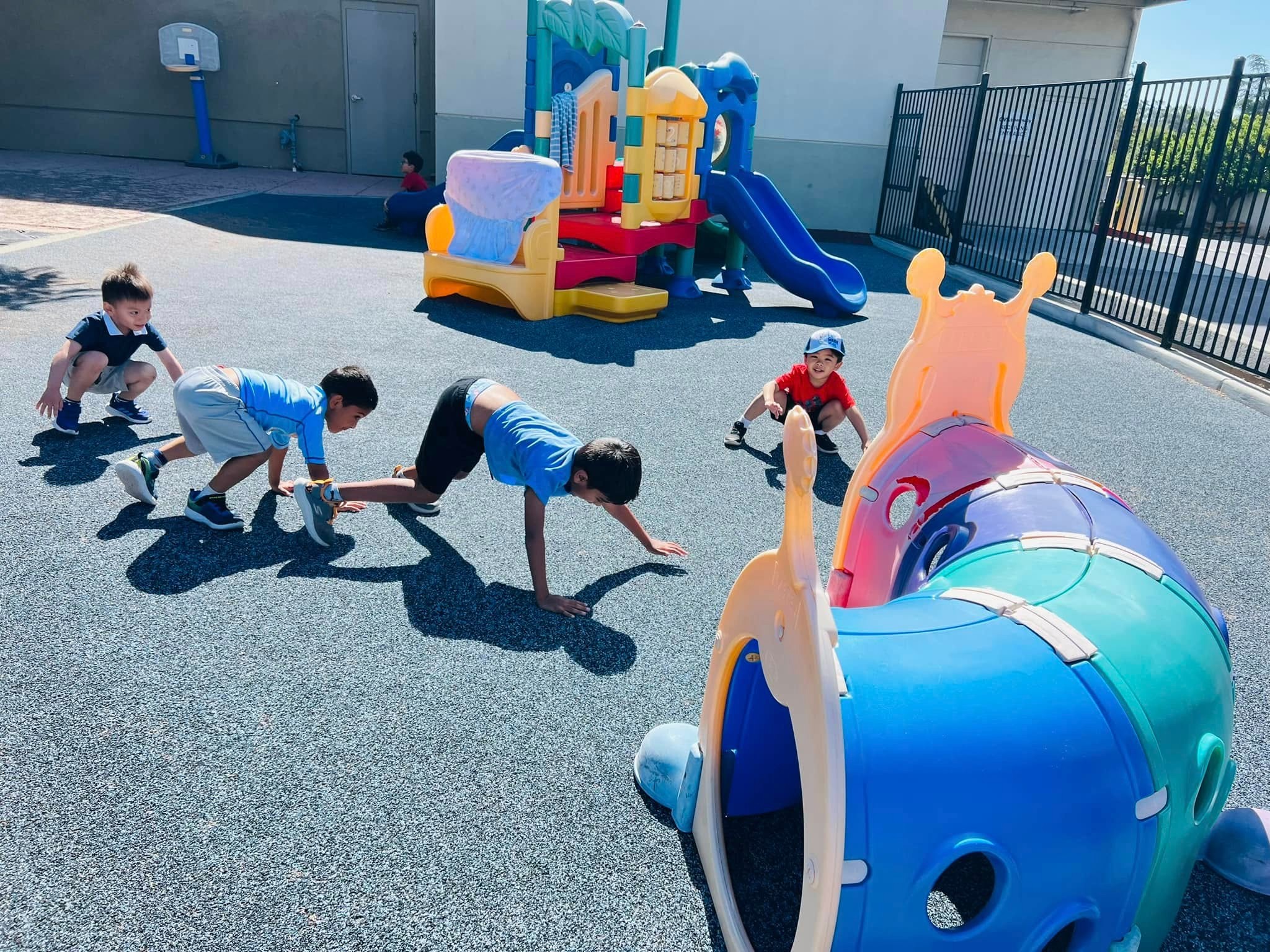 Children playing outdoors at Level Up Montessori after-school program for kindergartners.