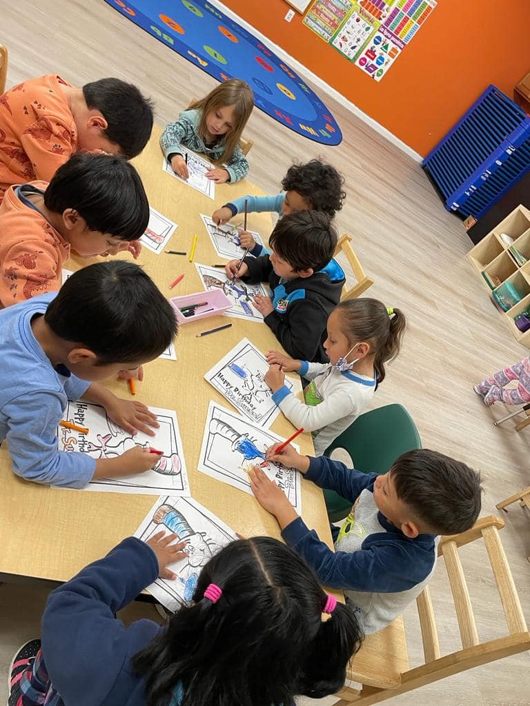 Children engaged in a coloring activity at Level Up Montessori classroom.