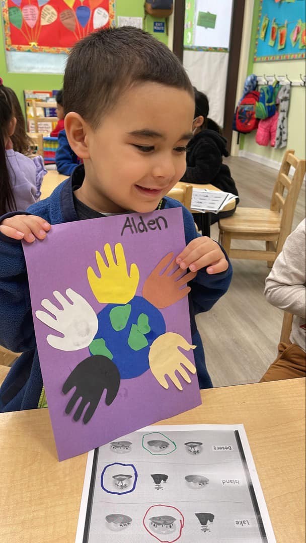 Child in Level Up Montessori preschool showcasing a colorful hands-on art project.