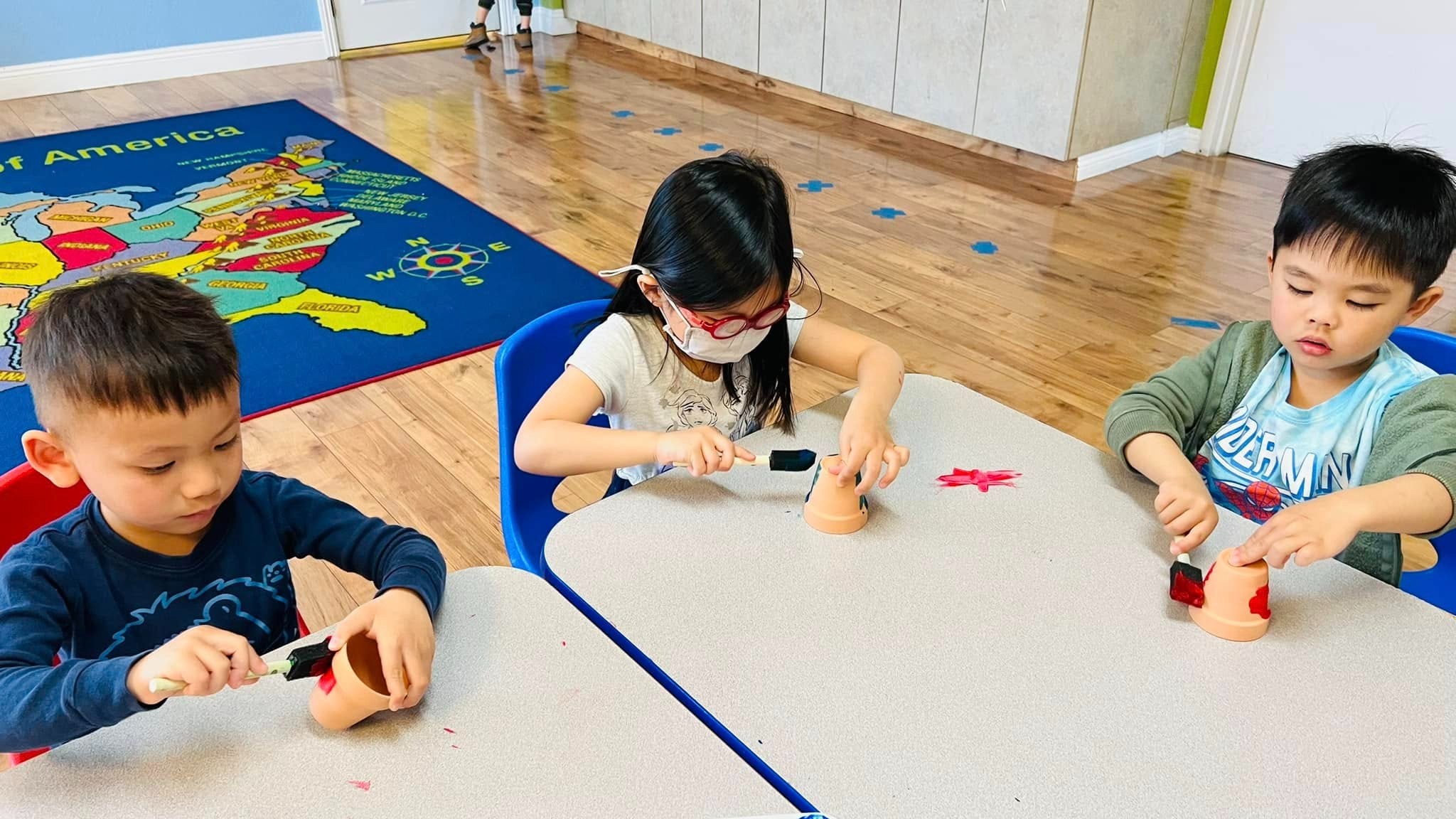 Children engaged in learning activity at Level Up Montessori classroom.