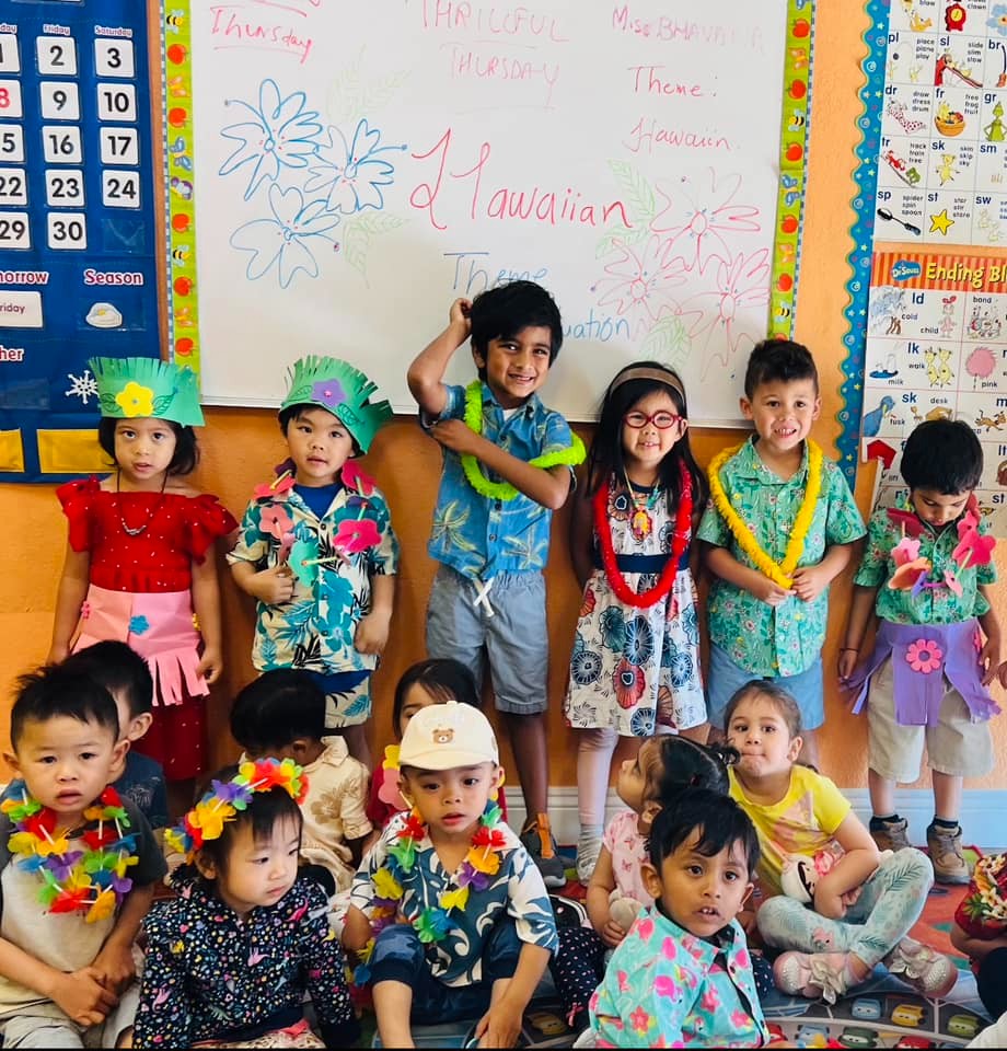 Children in Hawaiian outfits at Level Up Montessori enhancing confidence and early academic skills.