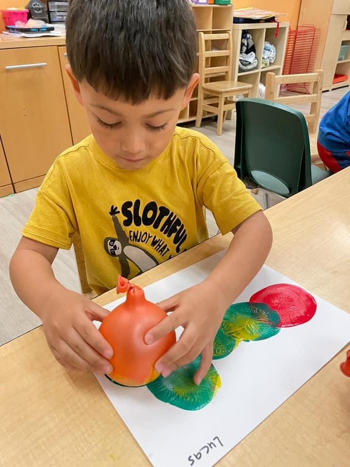 Child engaged in hands-on art activity at Level Up Montessori preschool.